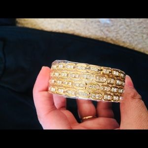 SET of four golden bangles with stones